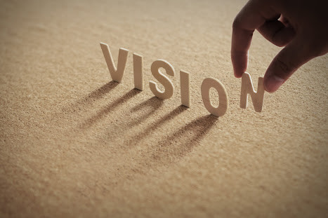 Vision Eine Hand stellt die Buchstaben des Wortes Vision auf