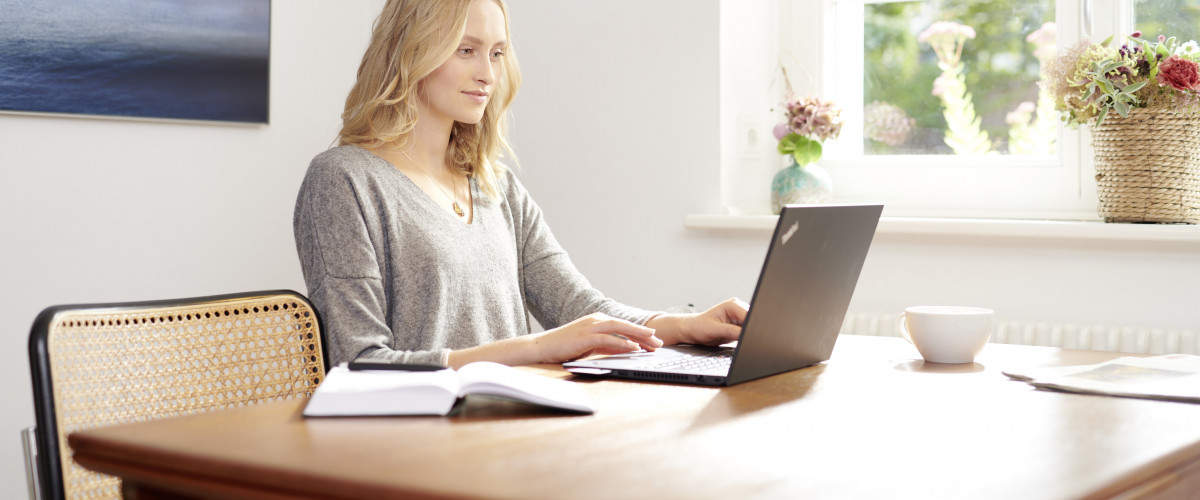 Eine Mitarbeiterin arbeitet im Homeoffice am Laptop